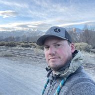 Portrait of Louis Wertz: Man standing by a railroad track